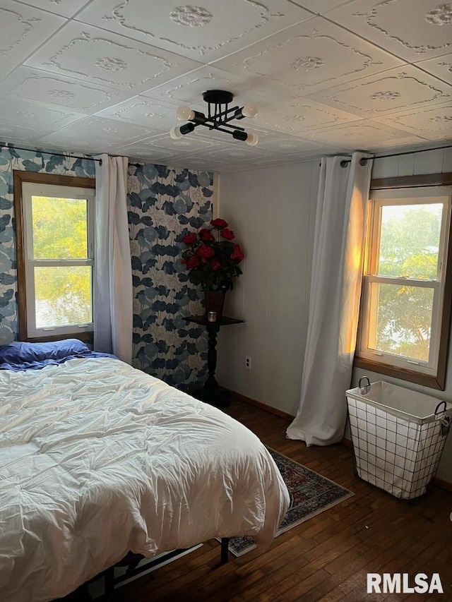 bedroom with dark wood-type flooring