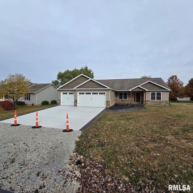 ranch-style house featuring a front yard and a garage