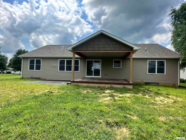 back of house with a yard and a patio