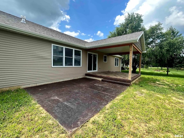 back of property with a patio and a lawn