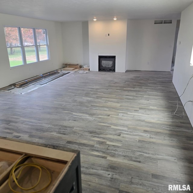 unfurnished living room featuring wood-type flooring