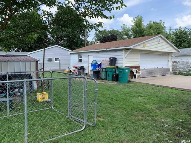 view of front facade with an outbuilding, a garage, and a front lawn