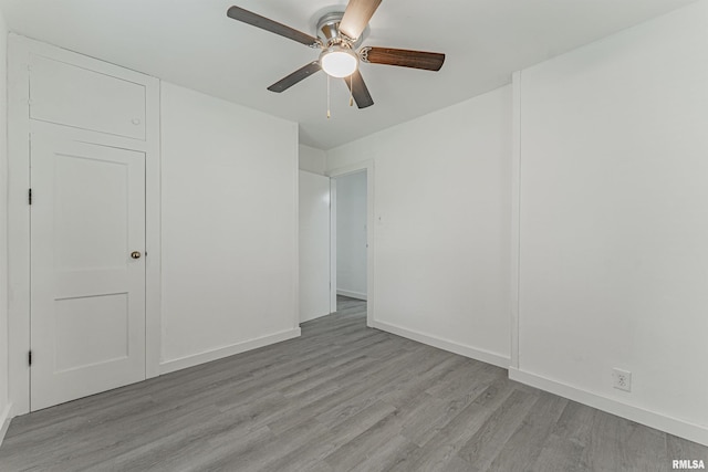 empty room featuring ceiling fan and light wood-type flooring