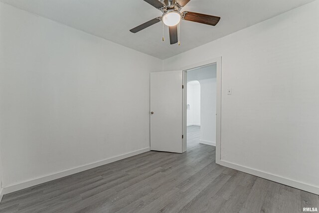 empty room featuring ceiling fan and hardwood / wood-style floors