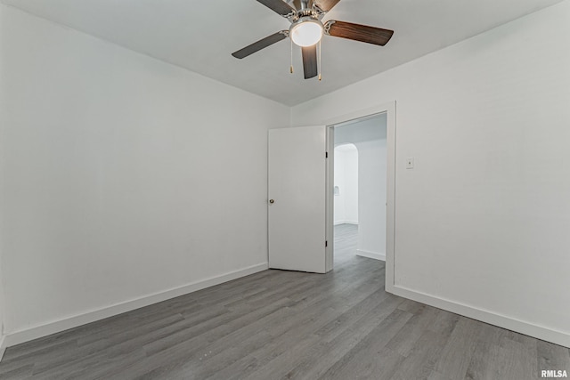 unfurnished room with ceiling fan and wood-type flooring