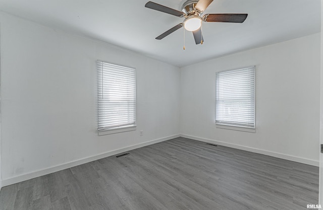 spare room with hardwood / wood-style floors and ceiling fan