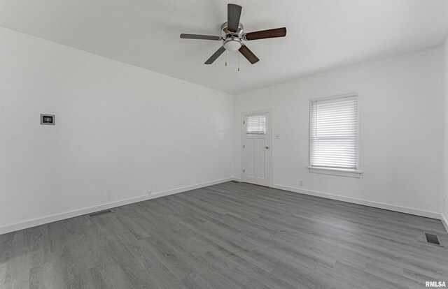 empty room featuring ceiling fan and hardwood / wood-style floors