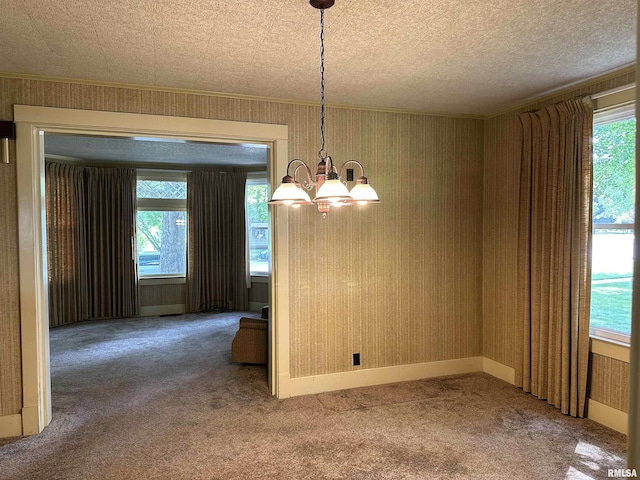 212 S Broadway St, Stronghurst, IL 61480 - unfurnished dining area with baseboards, wallpapered walls, carpet floors, and an inviting chandelier