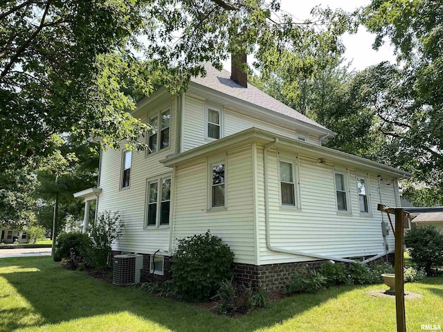 212 S Broadway St, Stronghurst, IL 61480 - view of home's exterior featuring a lawn, central AC, and a chimney