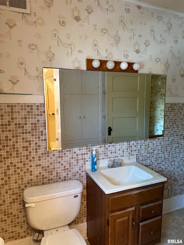 bathroom featuring vanity, backsplash, tile walls, and toilet