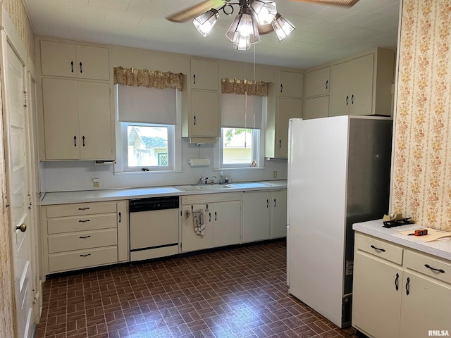 kitchen with white cabinets, white appliances, sink, and ceiling fan