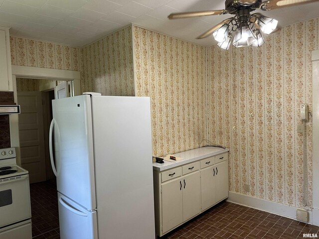 212 S Broadway St, Stronghurst, IL 61480 - kitchen with wallpapered walls, brick patterned floor, baseboards, and white appliances