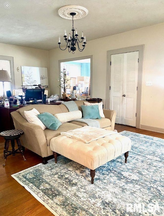 living room featuring a chandelier and dark wood-type flooring