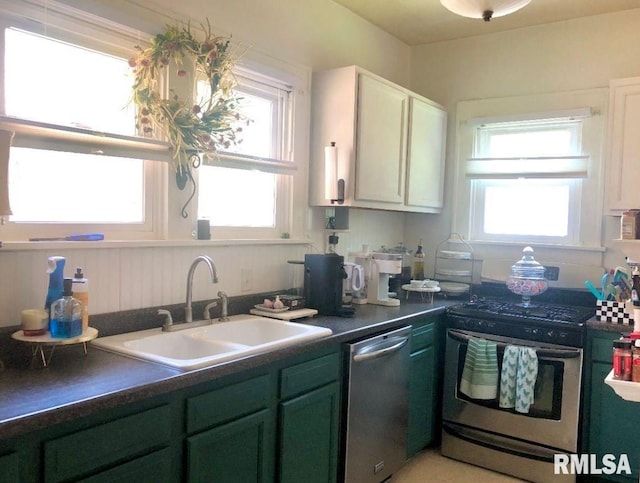 kitchen with white cabinetry, appliances with stainless steel finishes, sink, and green cabinetry