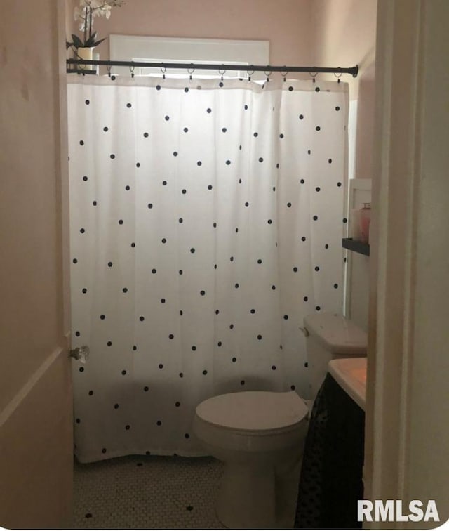 bathroom featuring tile patterned flooring and toilet