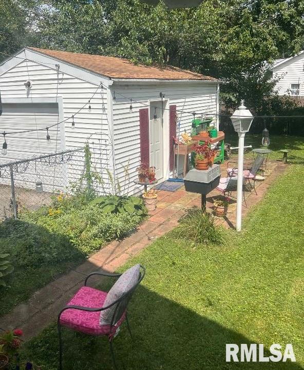 exterior space with a yard and a garage