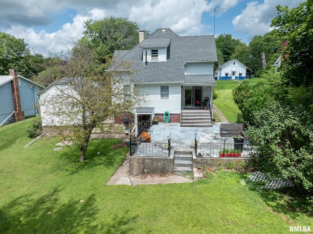 rear view of house featuring a lawn