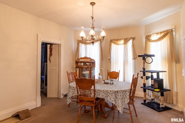 carpeted dining space with an inviting chandelier