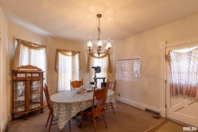 dining area featuring an inviting chandelier and carpet flooring