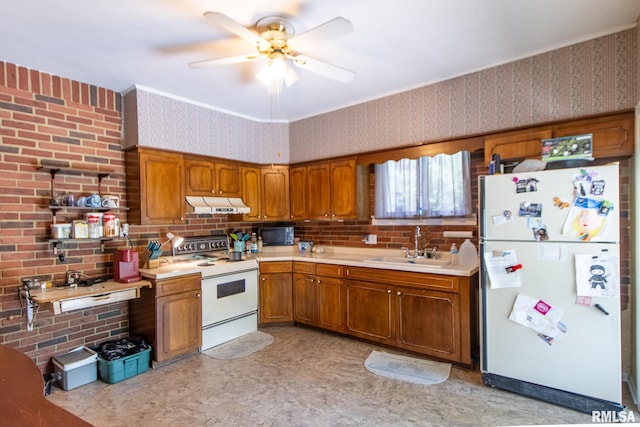 kitchen featuring brick wall, white appliances, sink, and ceiling fan