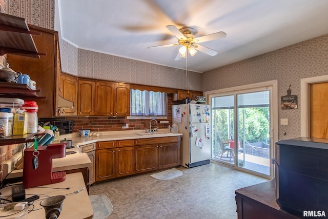 kitchen with extractor fan, white refrigerator, sink, light tile patterned flooring, and ceiling fan