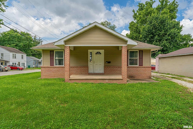 bungalow featuring a front lawn and covered porch