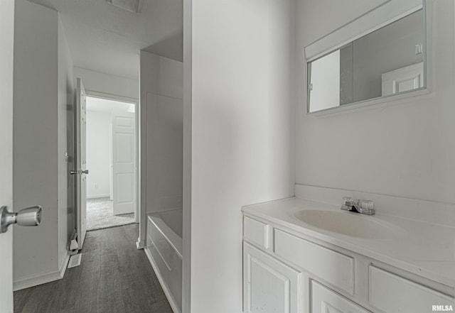 bathroom with vanity and hardwood / wood-style flooring