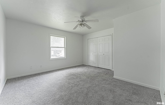 unfurnished bedroom featuring a closet, ceiling fan, and carpet flooring