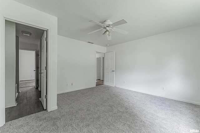 unfurnished bedroom featuring dark colored carpet and ceiling fan