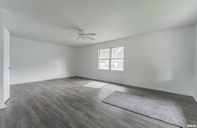 spare room with ceiling fan and dark hardwood / wood-style floors