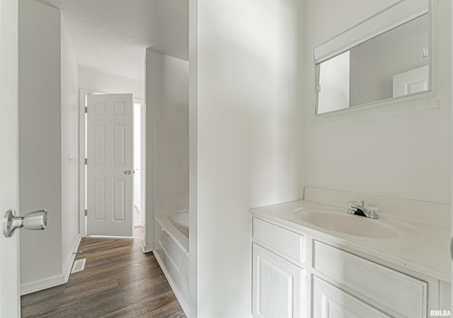 bathroom with vanity and hardwood / wood-style floors