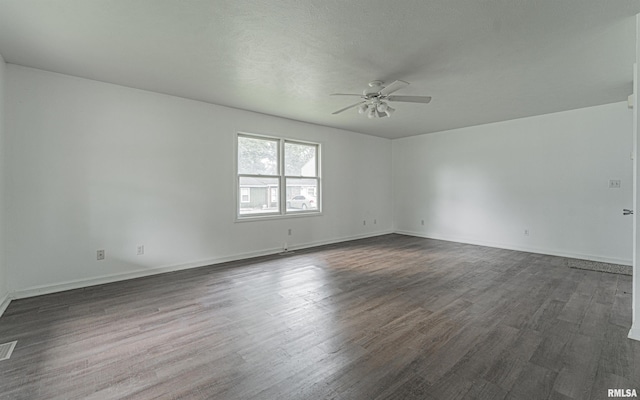 unfurnished room with ceiling fan and dark hardwood / wood-style flooring