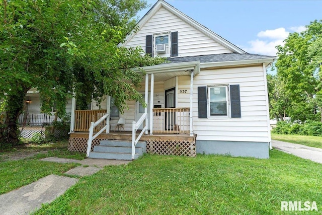 bungalow-style home with covered porch and a front yard