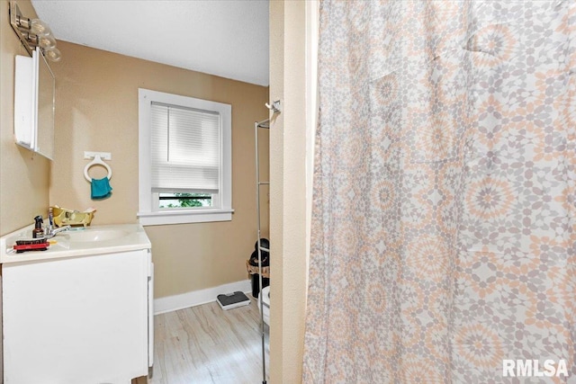 bathroom with vanity, hardwood / wood-style flooring, and walk in shower