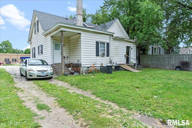 rear view of house featuring a yard and cooling unit