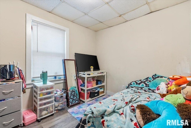 bedroom featuring a paneled ceiling and wood-type flooring