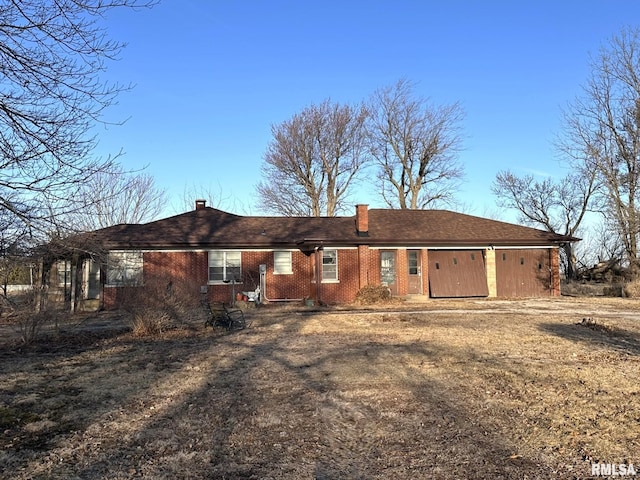 back of property featuring brick siding