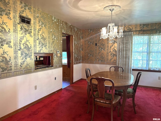 dining area with wallpapered walls, a notable chandelier, baseboards, and carpet floors