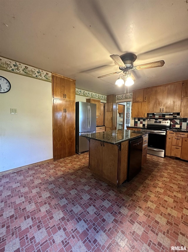 kitchen with brick patterned floor, appliances with stainless steel finishes, a kitchen island, and a ceiling fan