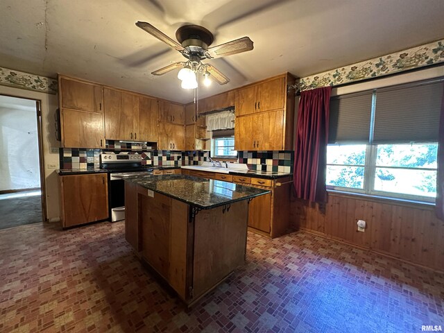 carpeted dining space featuring a notable chandelier and wallpapered walls