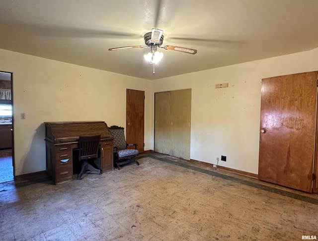 office space featuring ceiling fan, light floors, and baseboards