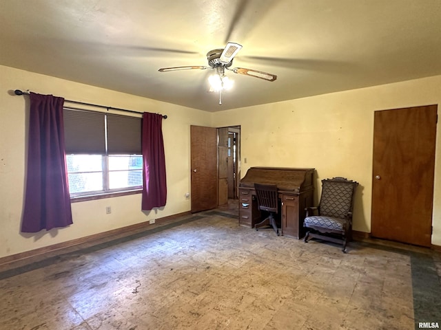 sitting room with ceiling fan, baseboards, and tile patterned floors