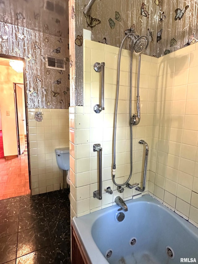 full bath with visible vents, toilet, a combined bath / shower with jetted tub, tile walls, and wallpapered walls