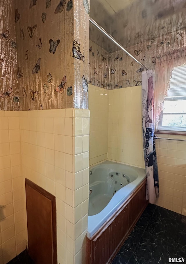 full bath with shower / tub combo with curtain and tile walls