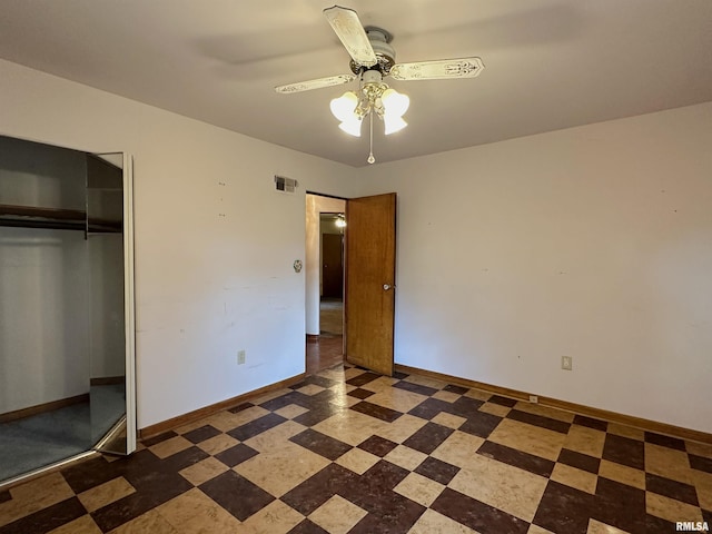 unfurnished bedroom with tile patterned floors, visible vents, a ceiling fan, a closet, and baseboards