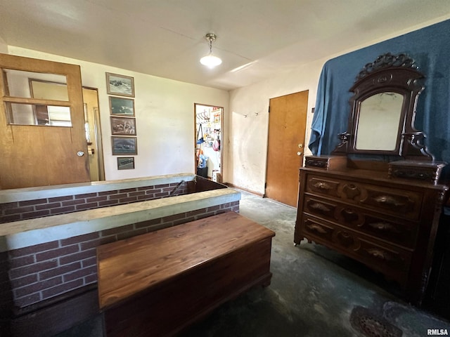 bedroom featuring unfinished concrete floors