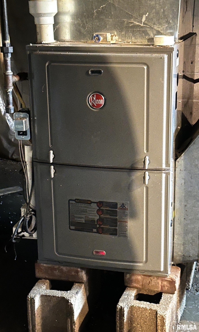 utility room featuring heating unit