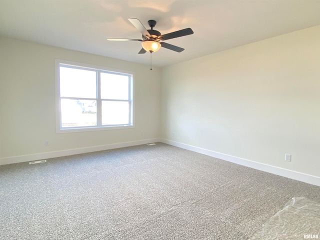 spare room featuring carpet and ceiling fan