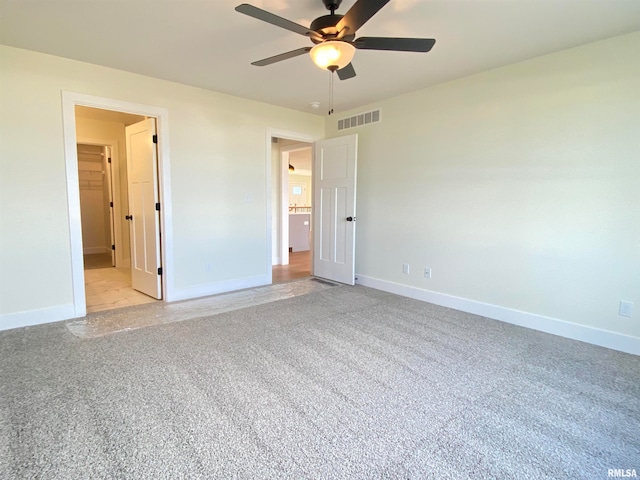 unfurnished bedroom featuring light carpet and ceiling fan