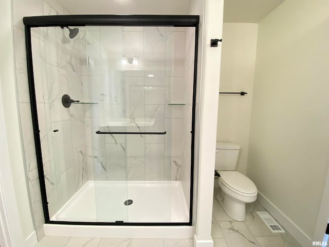 bathroom with toilet and a shower with door